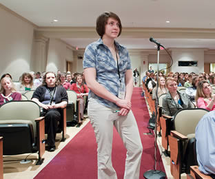 female-student-asking-question-at-lecture