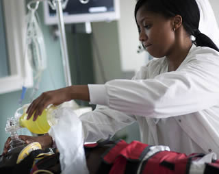 Nurse assistant working on patient 