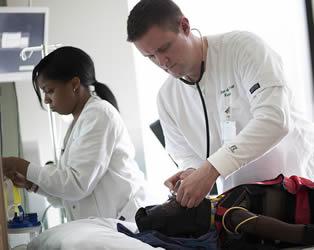 nursing-trainees-practicing-on-medical-dummy