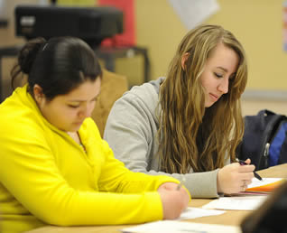 college-students-writing-in-class