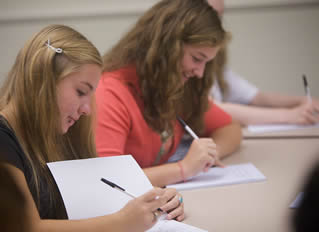 girl-college-students-writing-in-class