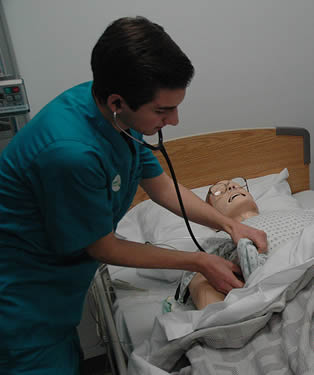 nurse-aide-practicing-procedures-on-dummy