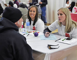 female-nursing-students-speaking-at-school-event