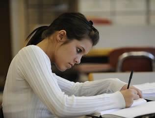 college-female-student-writing-at-desk