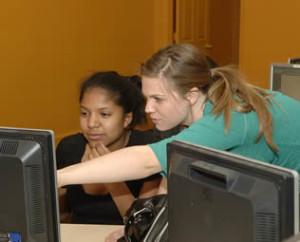 college-women-students-using-computer-in-class-000024476276253833