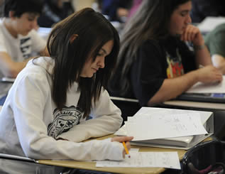 students-sitting-at-desks-in-classroom