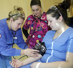 Nurse aide taking blood pressure