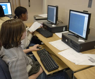 two-young-school-students-on-computer