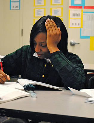 black-college-student-writing-in-notebook