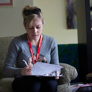 college-woman-writing-on-clipboard