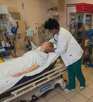 Nursing assistant checking vital signs on the job