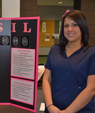 nursing-student-in-scrubs-giving-presentation