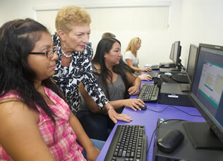 instructor-helping-students-at-computer