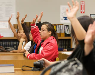 students-raising-arms-in-class