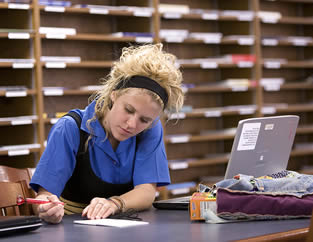 college-student-writing-at-desk