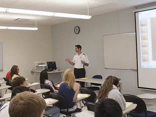 professor-speaking-to-college-students