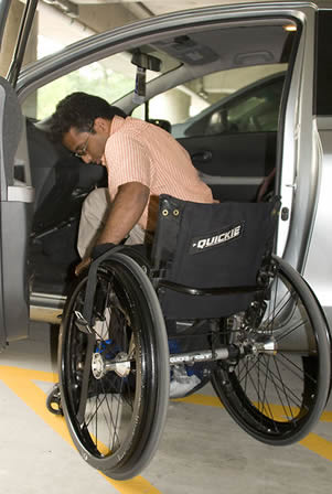 assisting-a-disabled-man-in-wheelchair
