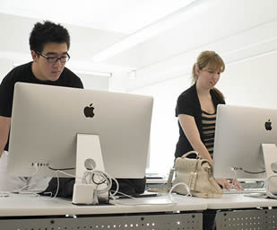 two-students-using-mac-computers