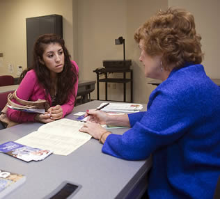 hispanic-student-speaking-to-instructor