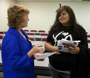 instructor-talking-with-student-in-college-class