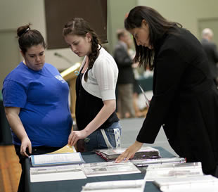 college-girls-looking-at-class-information