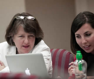 instructor-and-student-using-apple-laptop