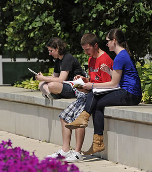 students-sitting-on-college-campus