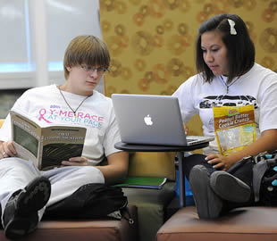 two-students-on-apple-laptop