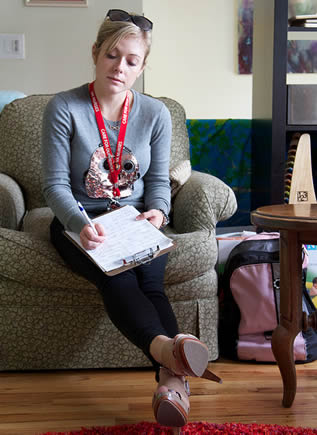 young-college-woman-filling-out-information-on-clipboard