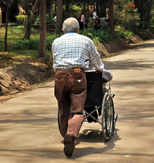 man-pushing-wheelchair-5543
