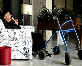 man-with-walker-eating-ice-cream-in-care-home-330