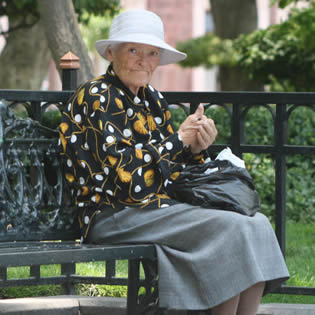 old-woman-sitting-on-bench-2201