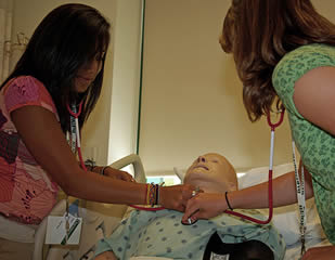 health care practice training with stethoscope on human dummy
