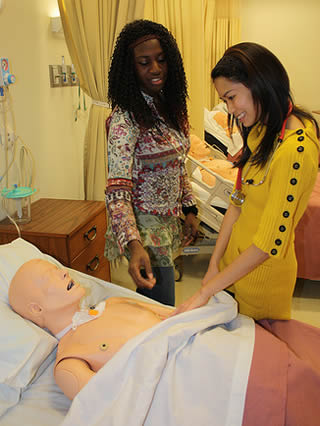 CNA workers practice skills for certification test