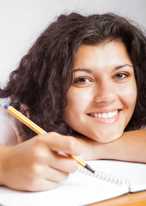 student-smiling-working-on-studies