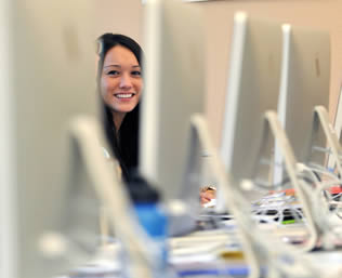 smiling-college-girl-looking-computer