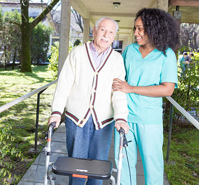 African American nursing assistant with elderly patient