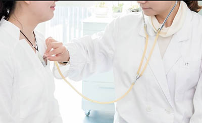 Nursing assistant taking pulse from test patient